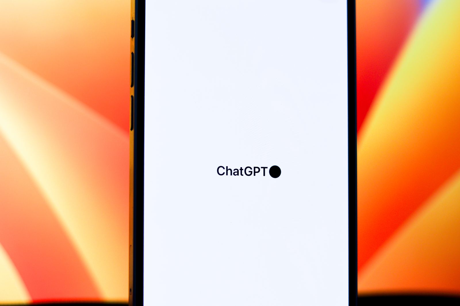 A smartphone displaying the ChatGPT app loading screen against a vibrant orange background