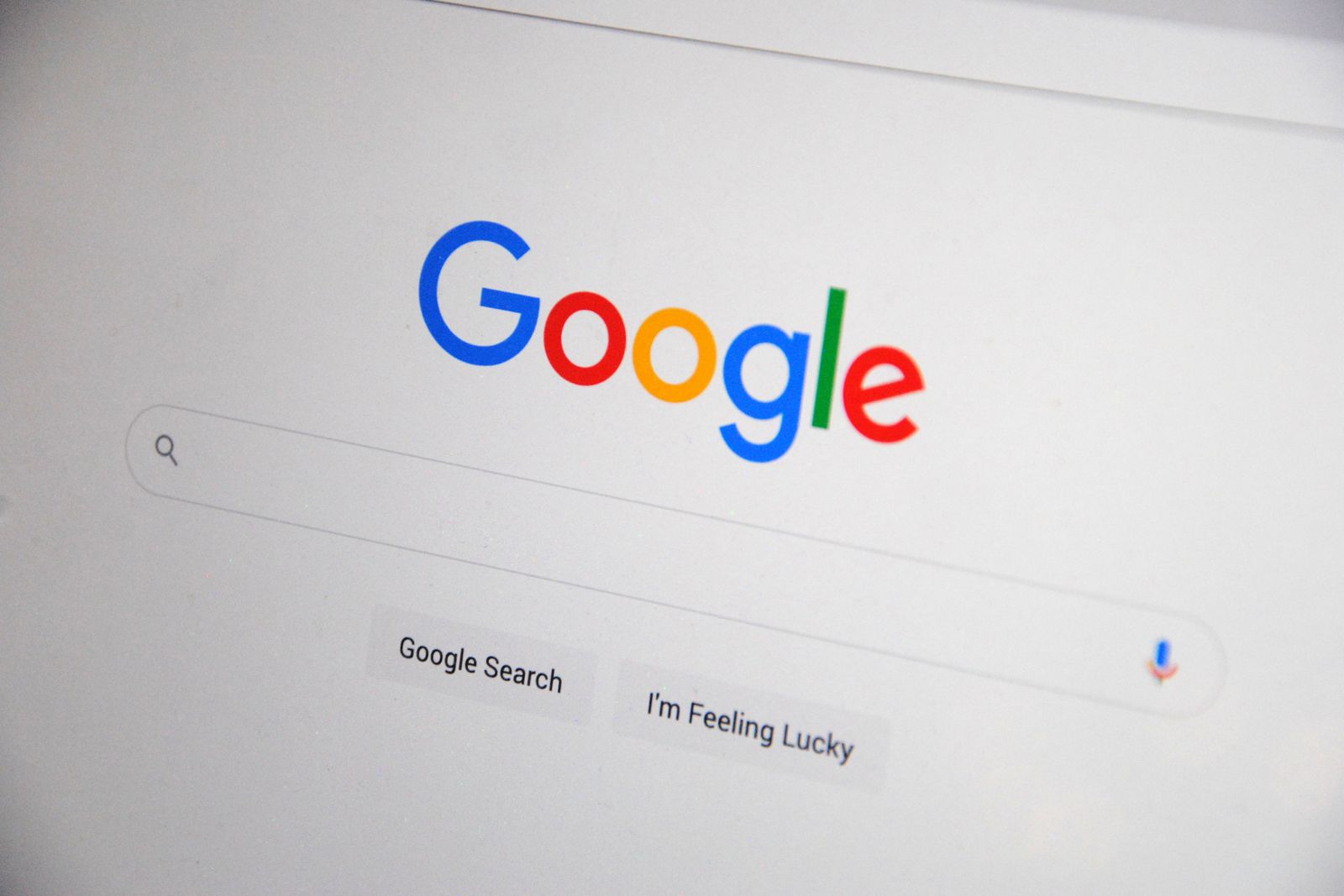 A laptop screen showing the Google homepage and search bar