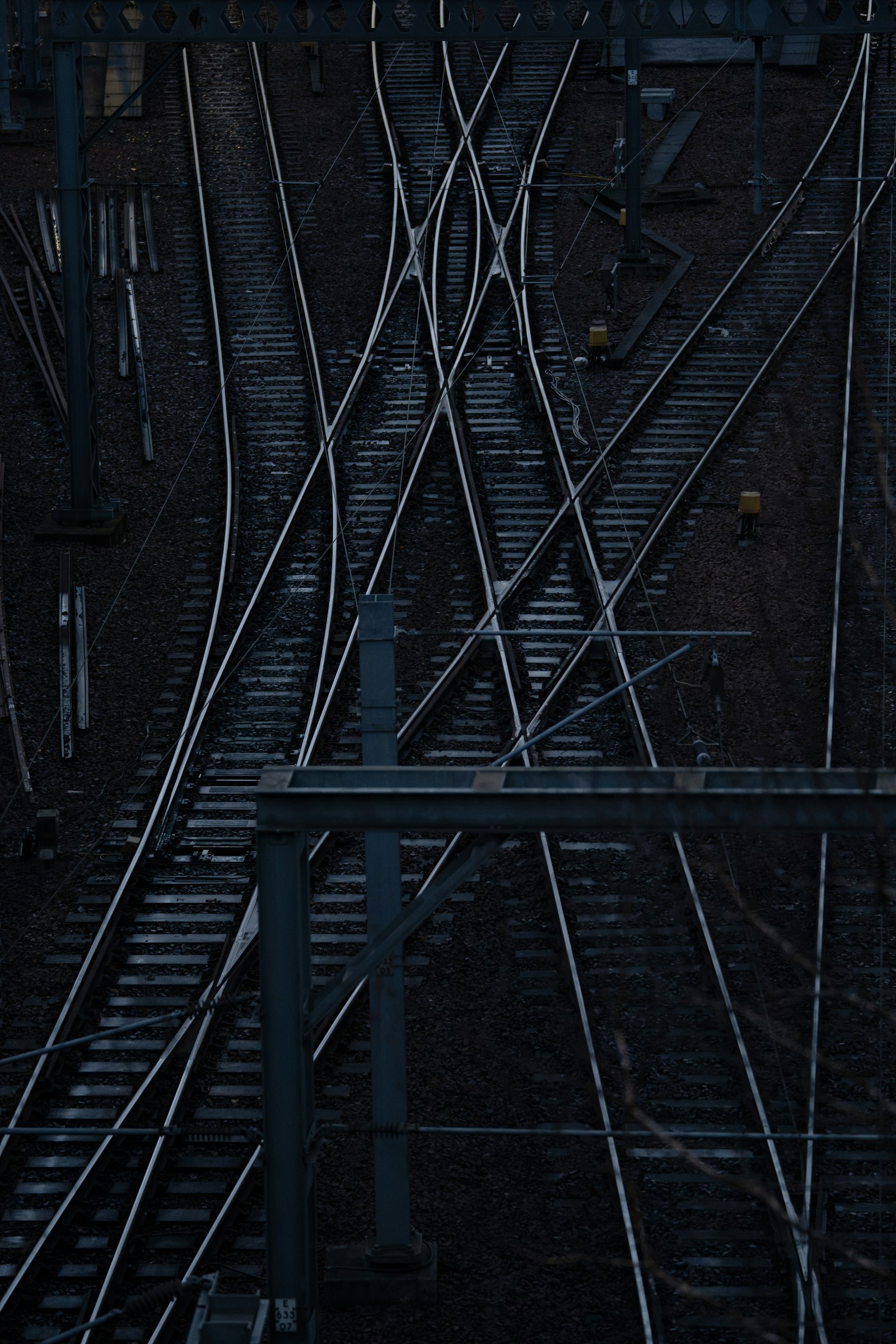 Railway tracks diverging through a junction at dusk