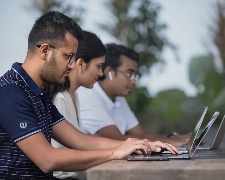 Colleagues working side by side on laptops